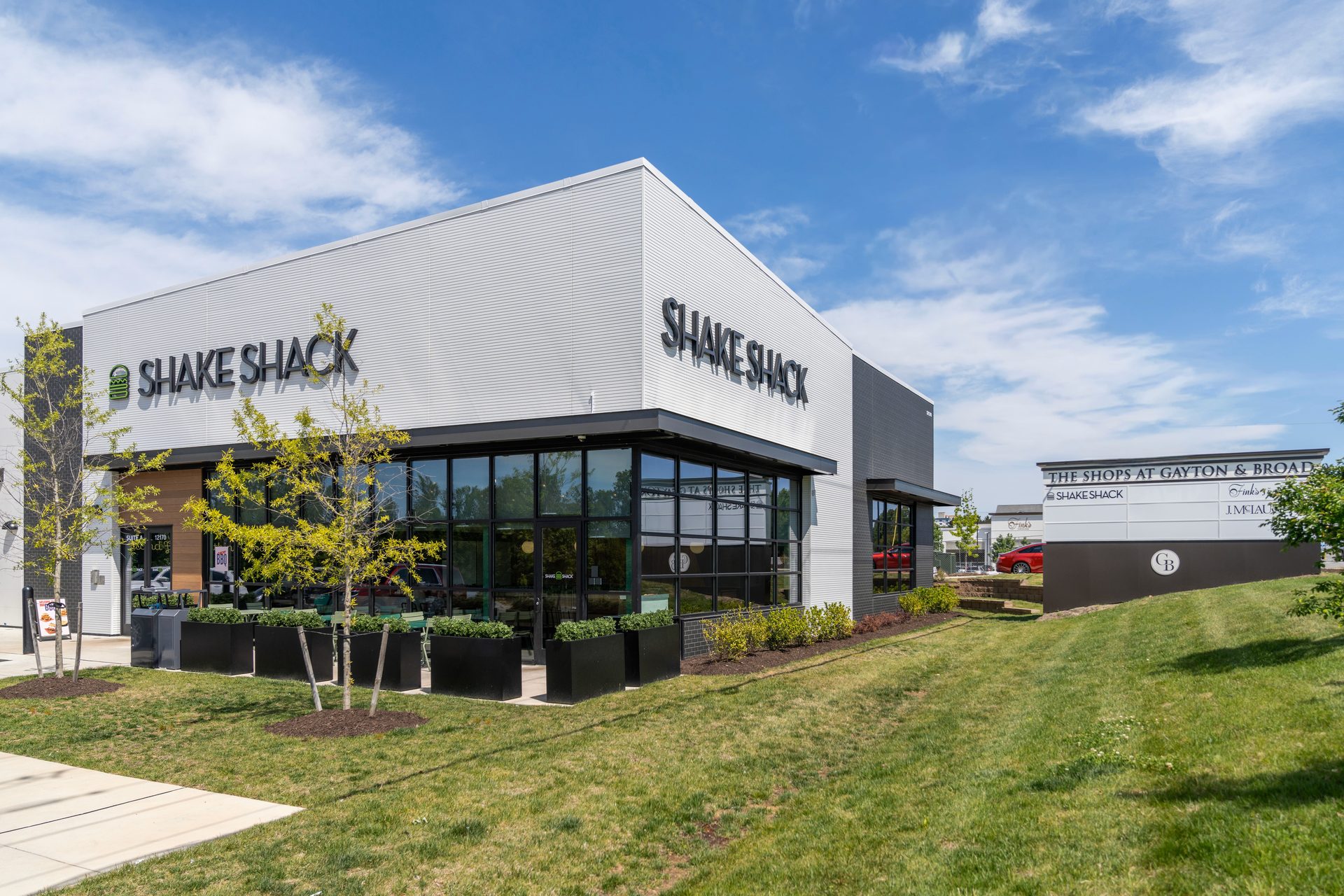 Shake Shack’s exterior and landscaped patio at Gayton & Broad
